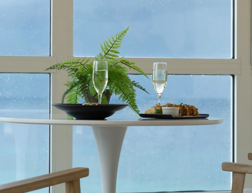 a table with a plant and a plate of food on it