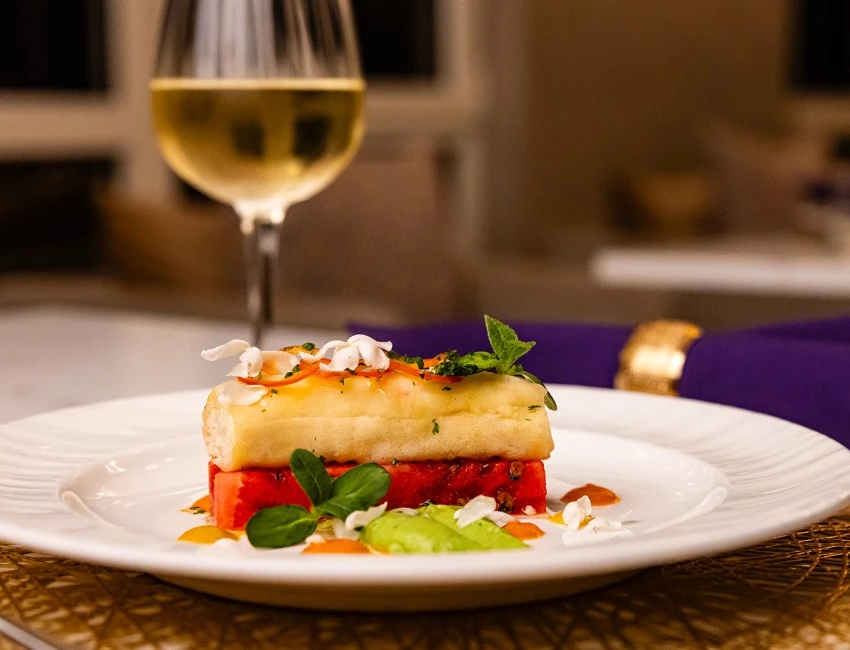 a plate of food and a glass of wine
