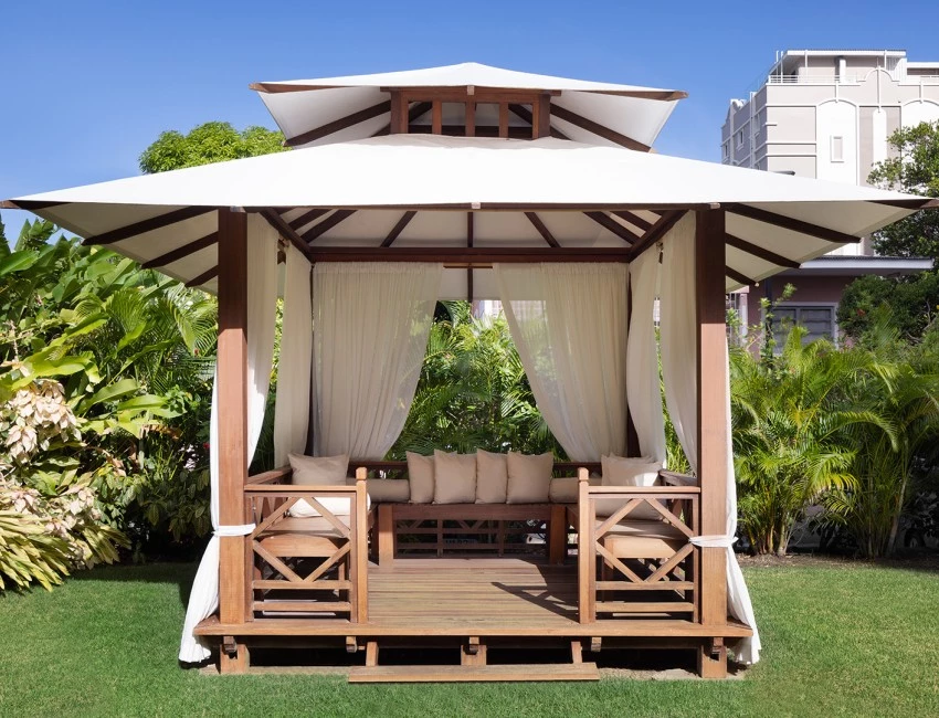 a gazebo with white curtains and a white canopy