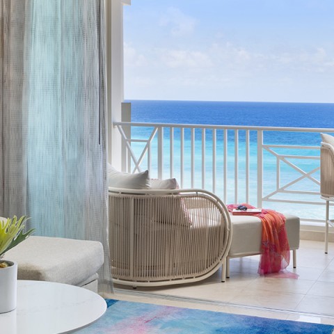 a room with a balcony overlooking the ocean
