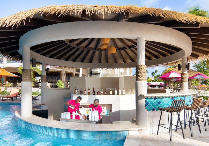 bartenders making drinks in the swim up bar