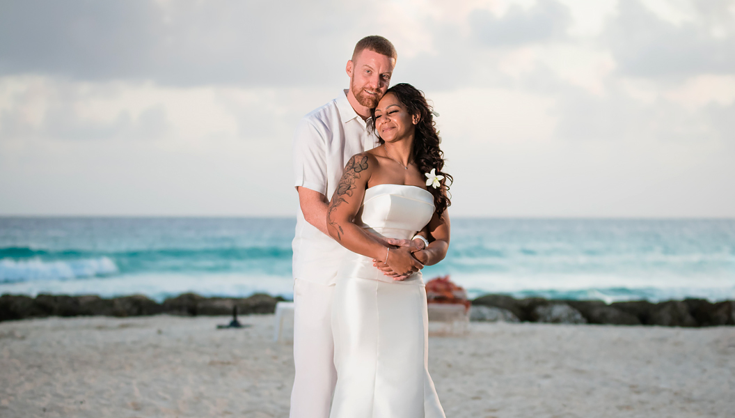 bride and groom hugging on the beach