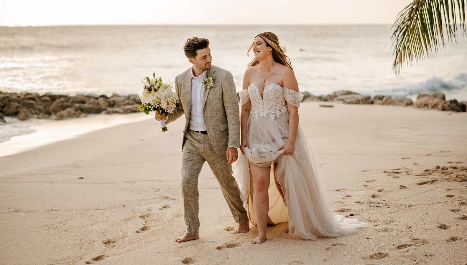 a man and woman walking on a beach