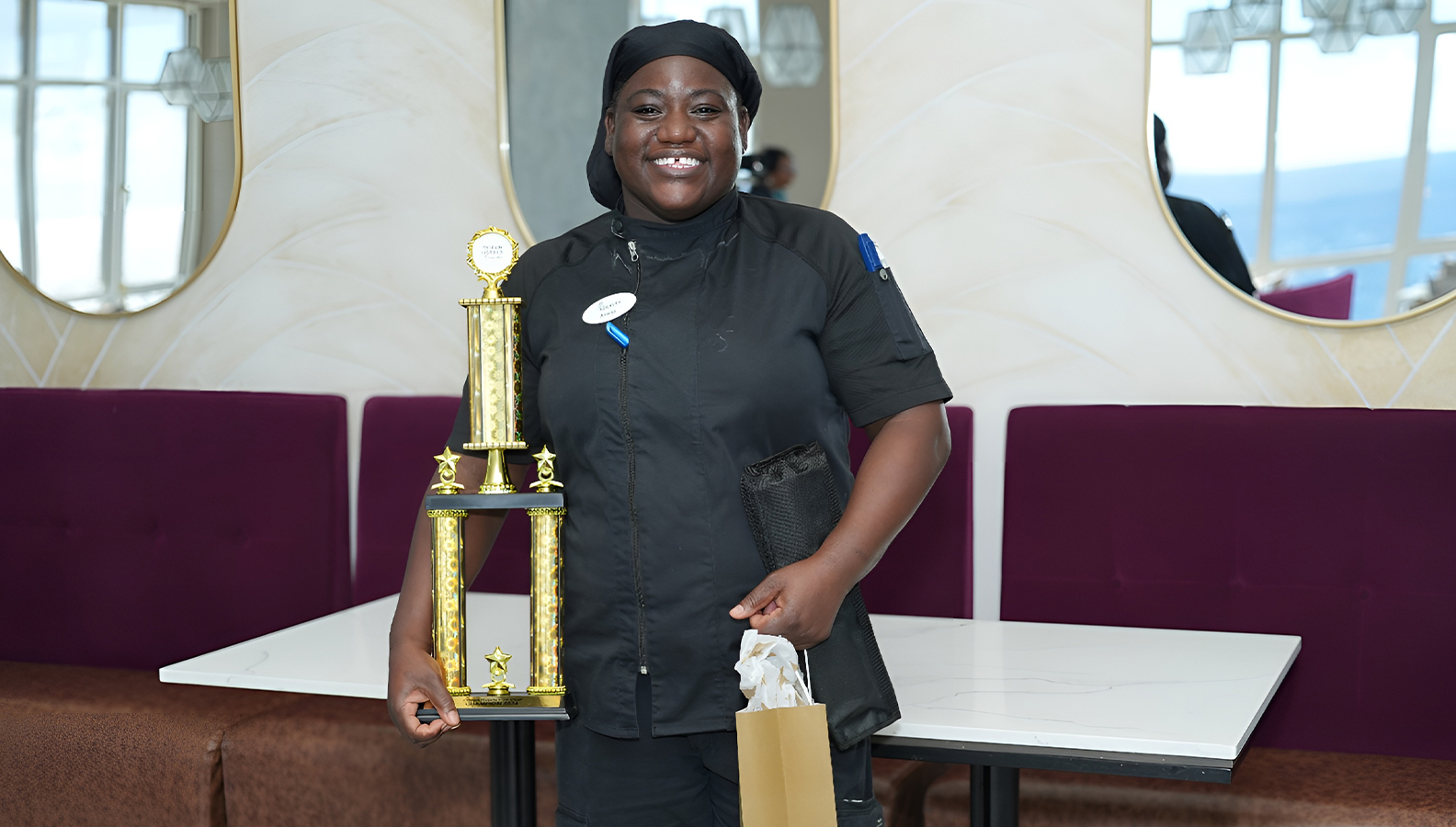 a woman holding a trophy