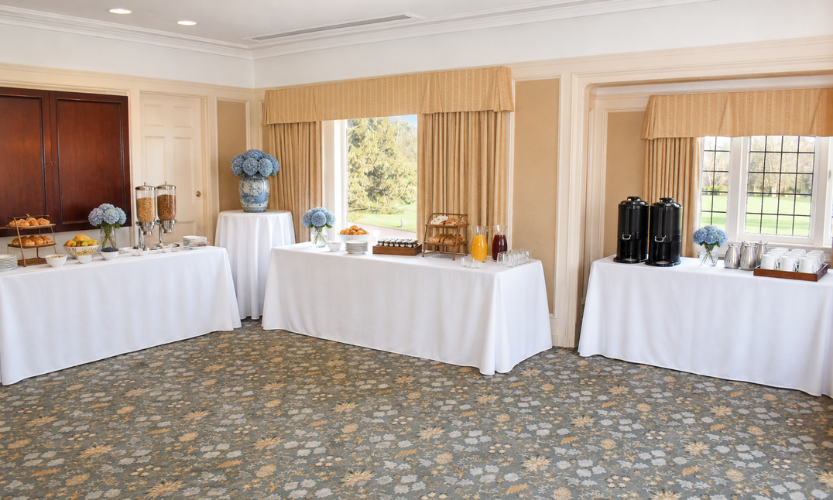 a buffet table with white tablecloths and drinks