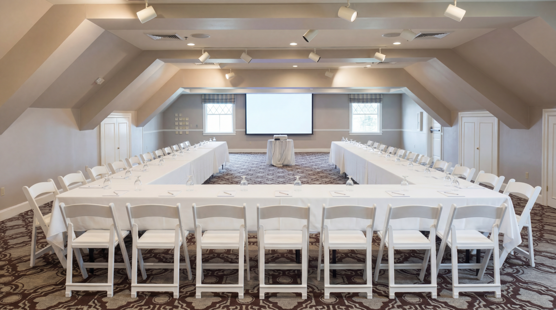 a room with a large table and chairs