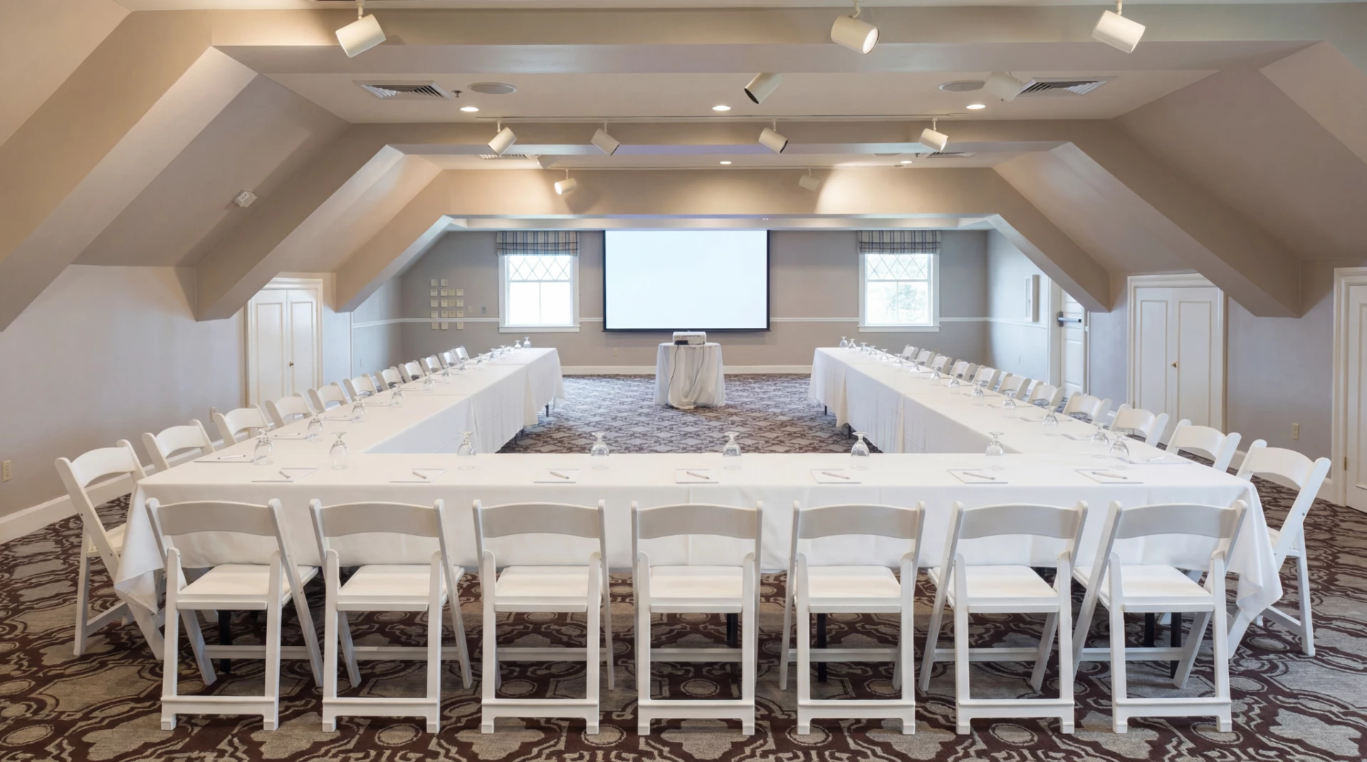 a room with a large table and chairs