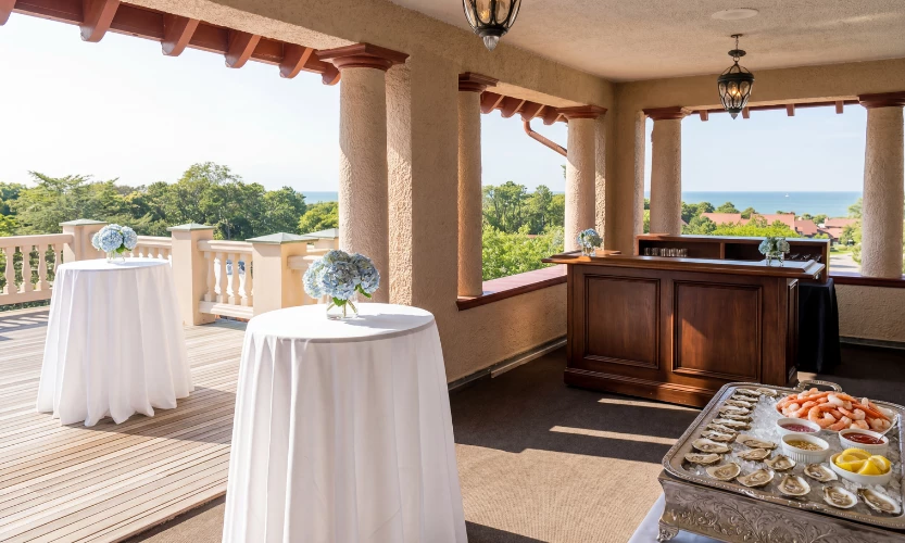 a table with a white tablecloth and a buffet on a porch