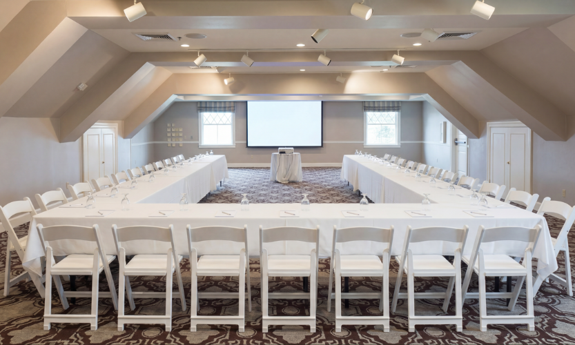 a room with a large table and chairs