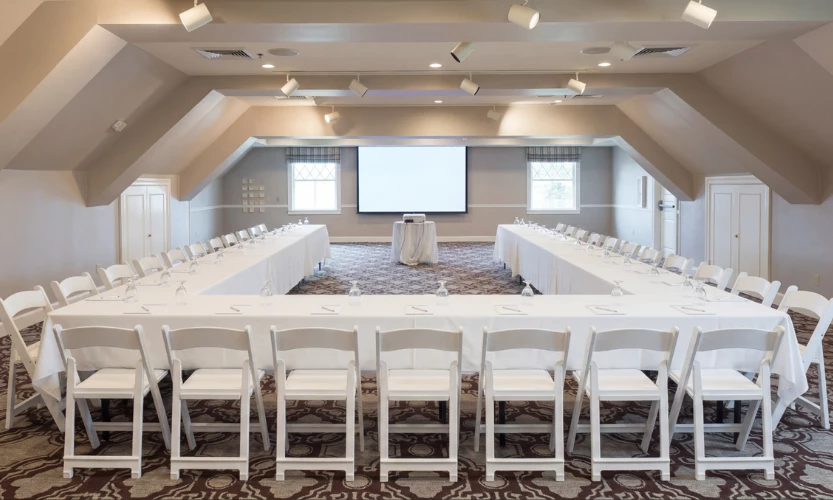 a room with a large table and chairs