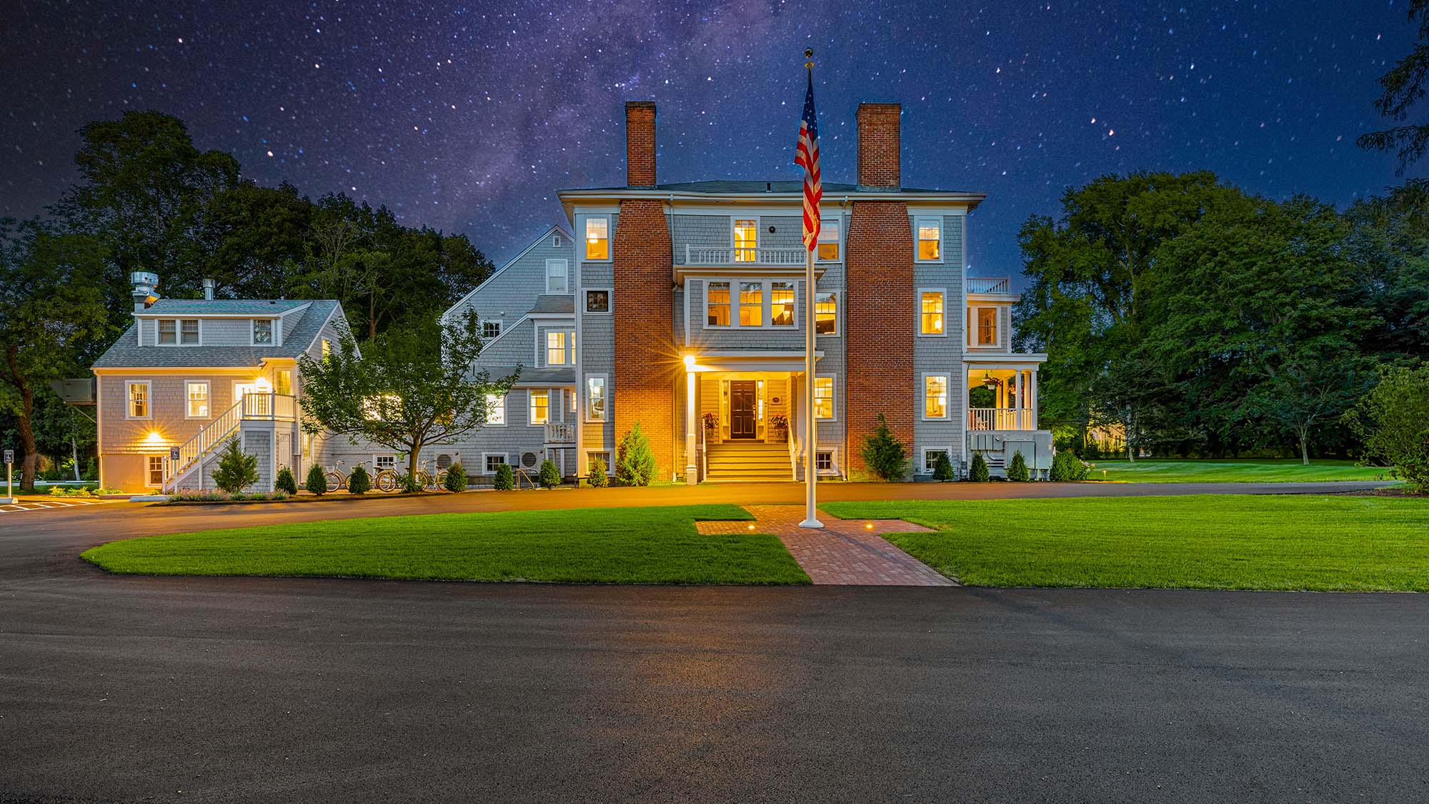 a large inn with a flag pole in front of it