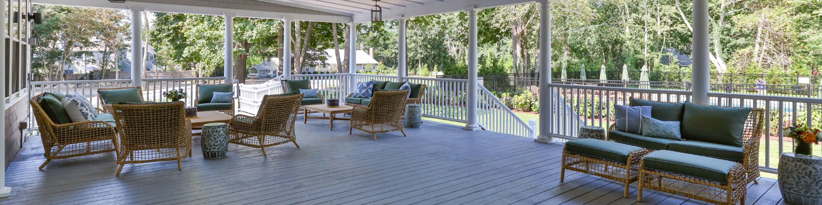 a porch with a white railing and a white railing