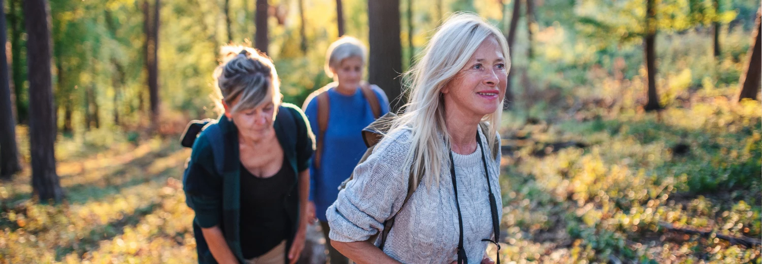 a group of women hiking in the woods