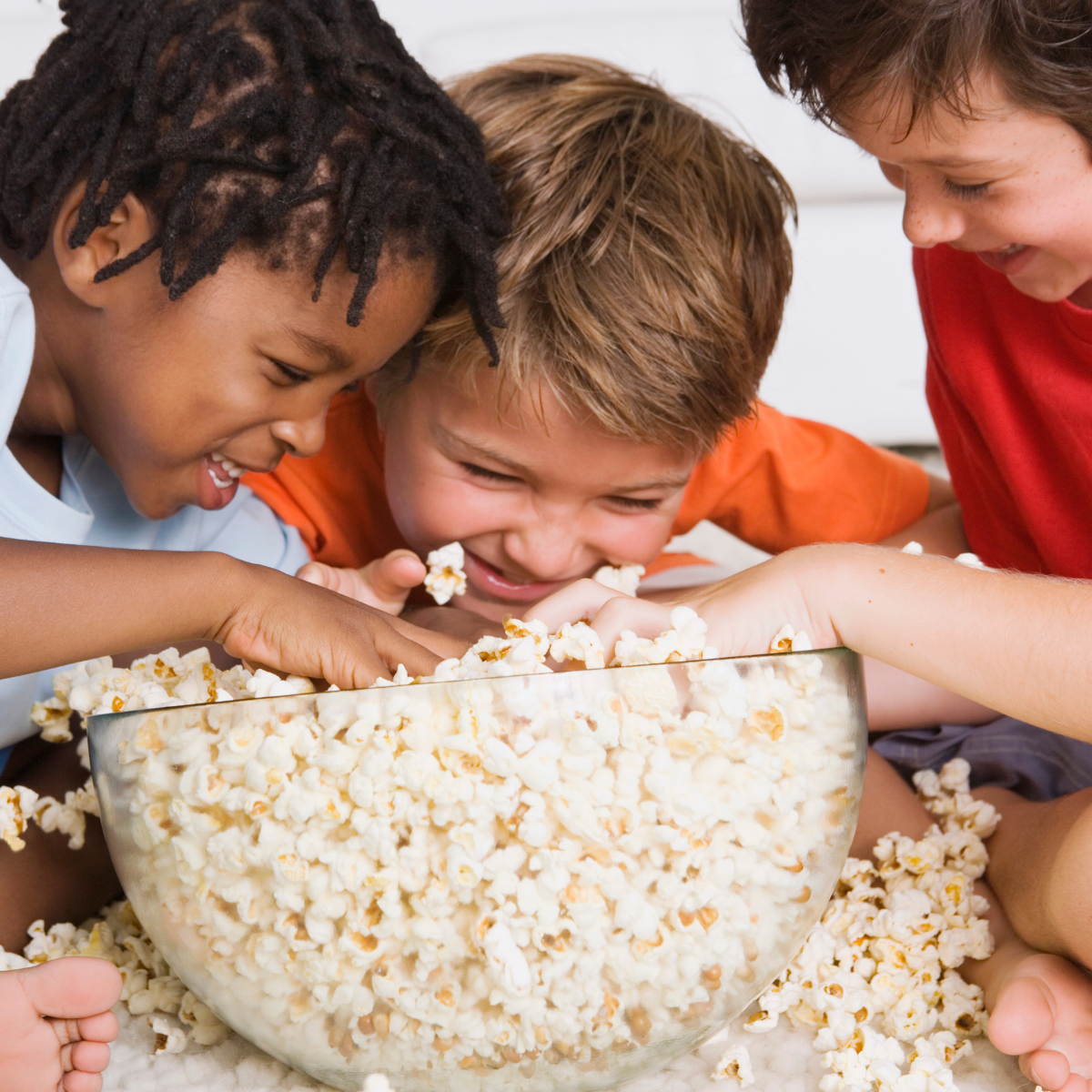 a group of kids eating popcorn