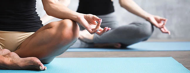 two women at a yoga class