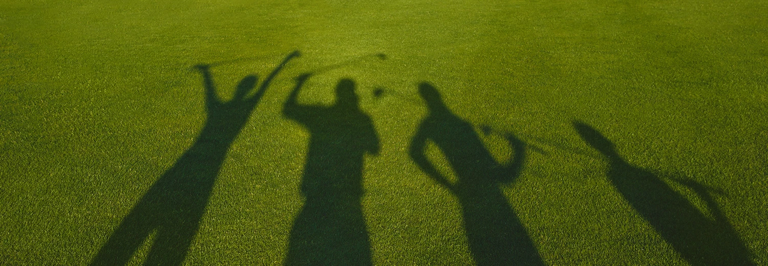 shadows of people playing golf