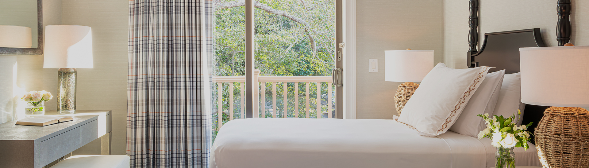 a bed with a white sheet and a white curtain
