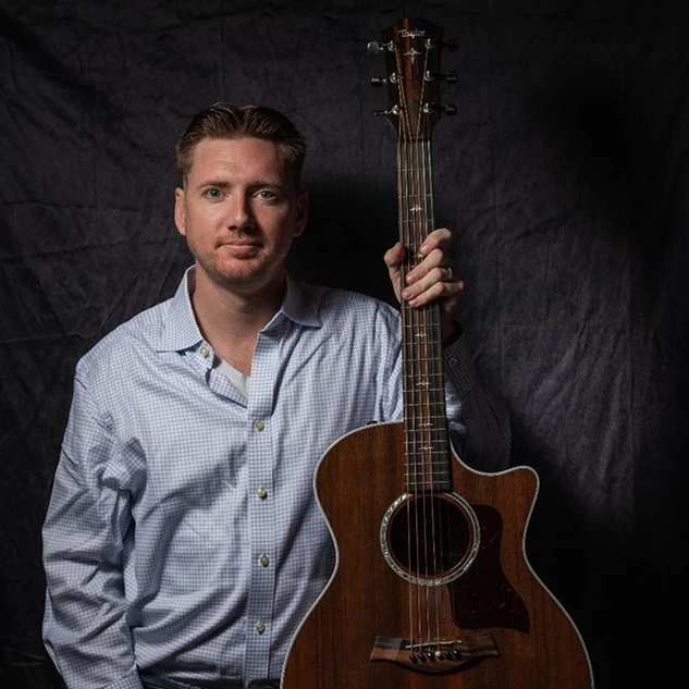a man holding a guitar