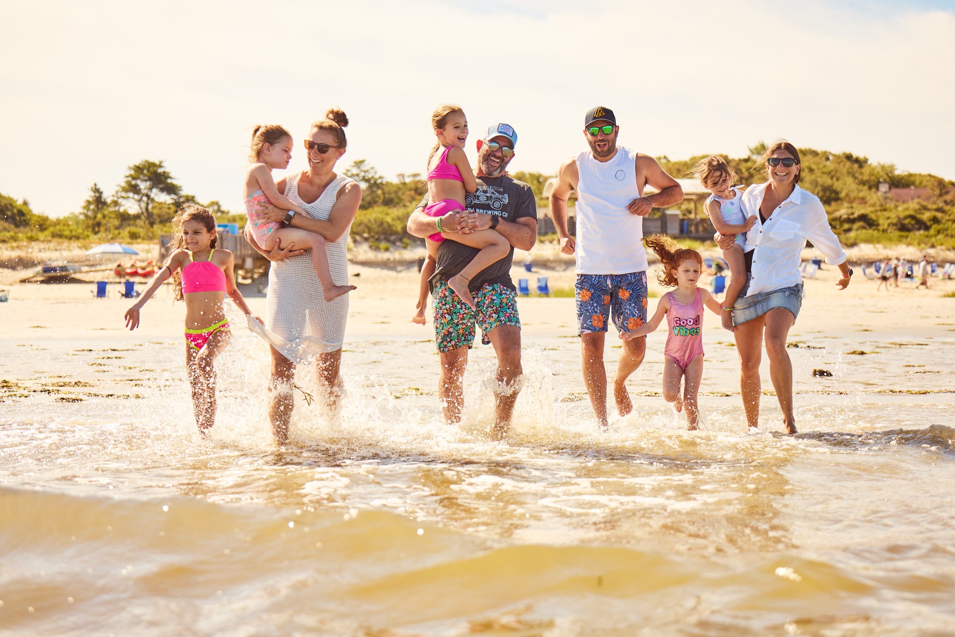 a group of people running in water
