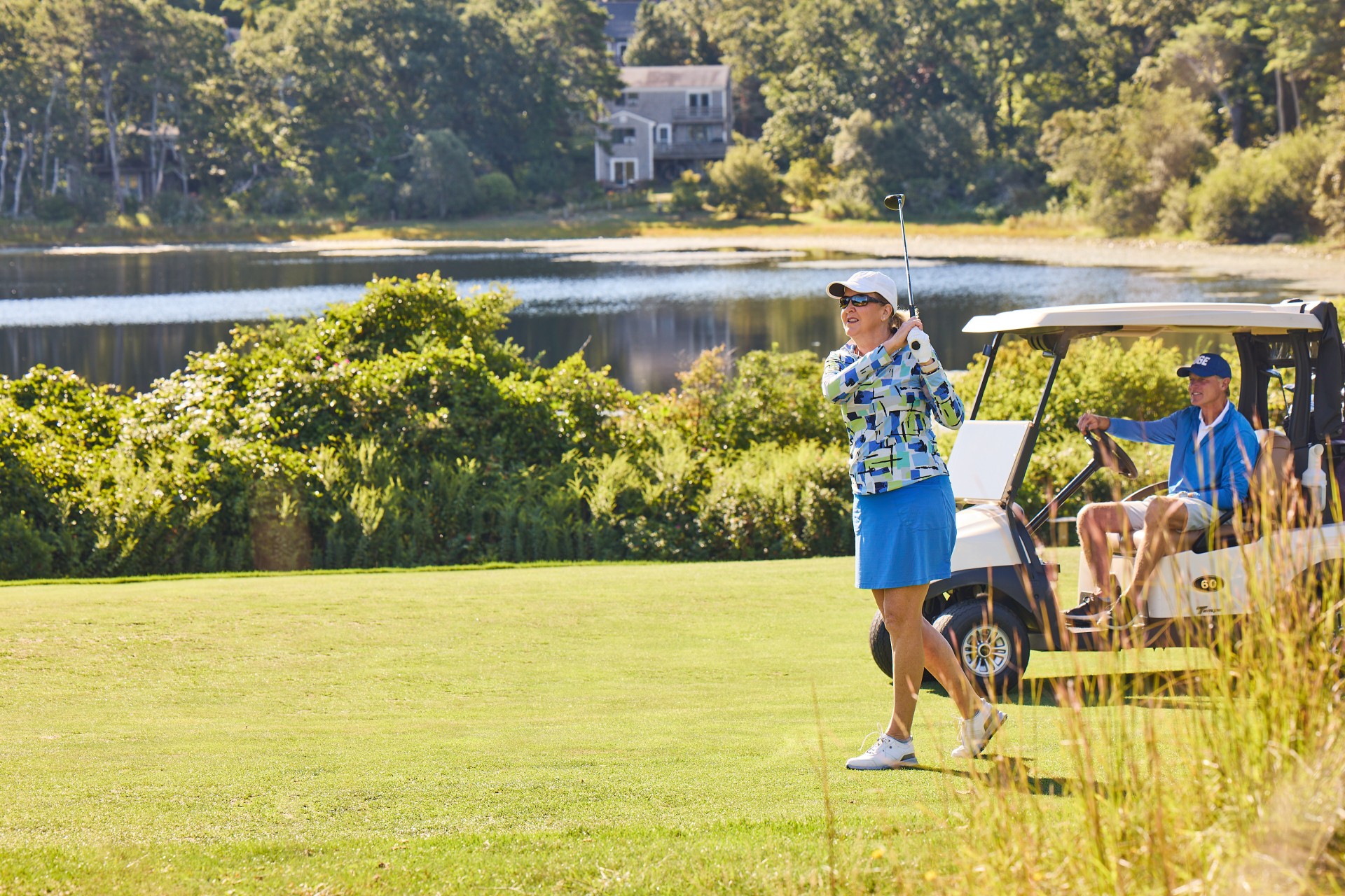 a woman swinging a golf club