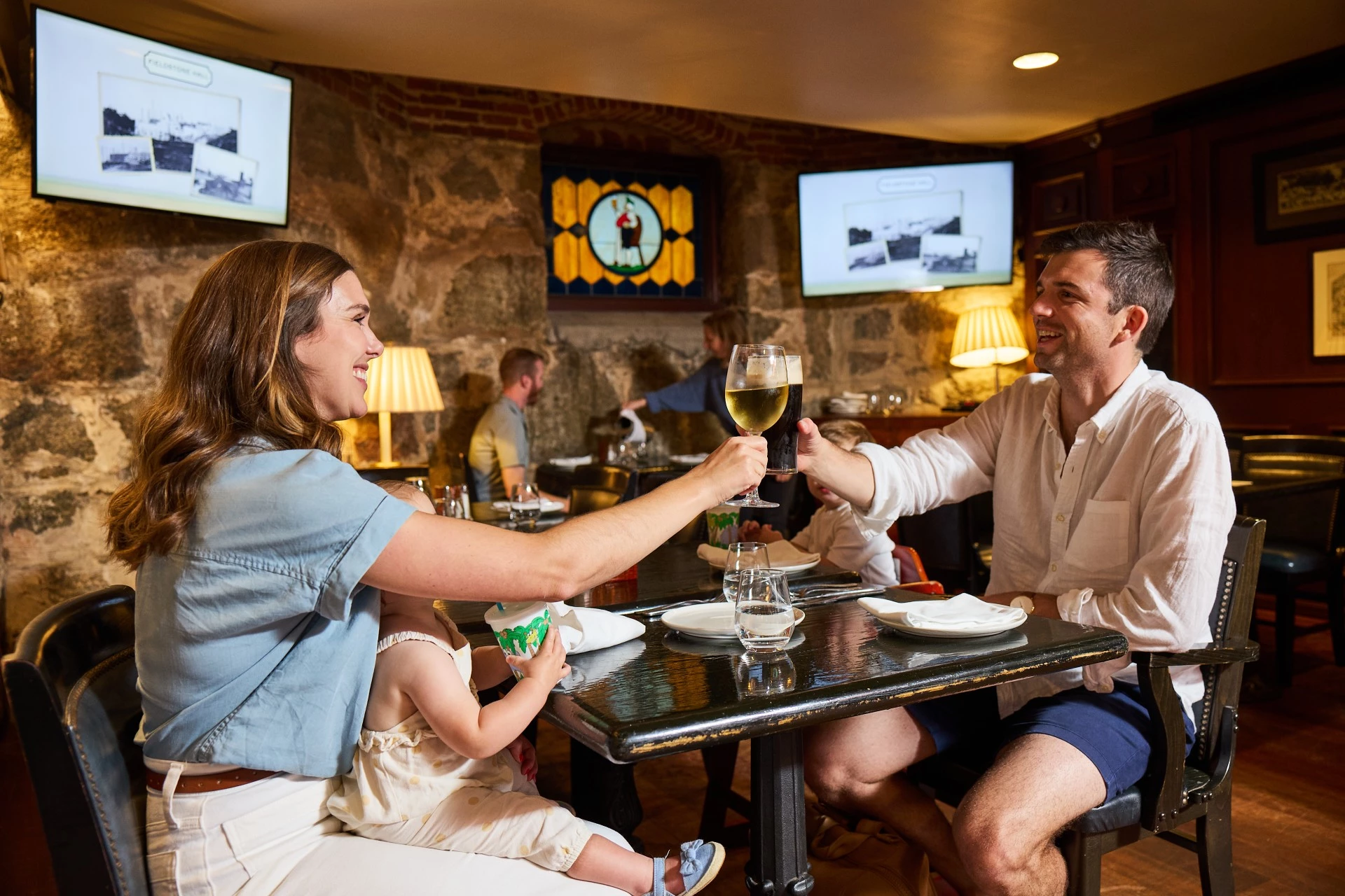 a man and woman sitting at a table with drinks