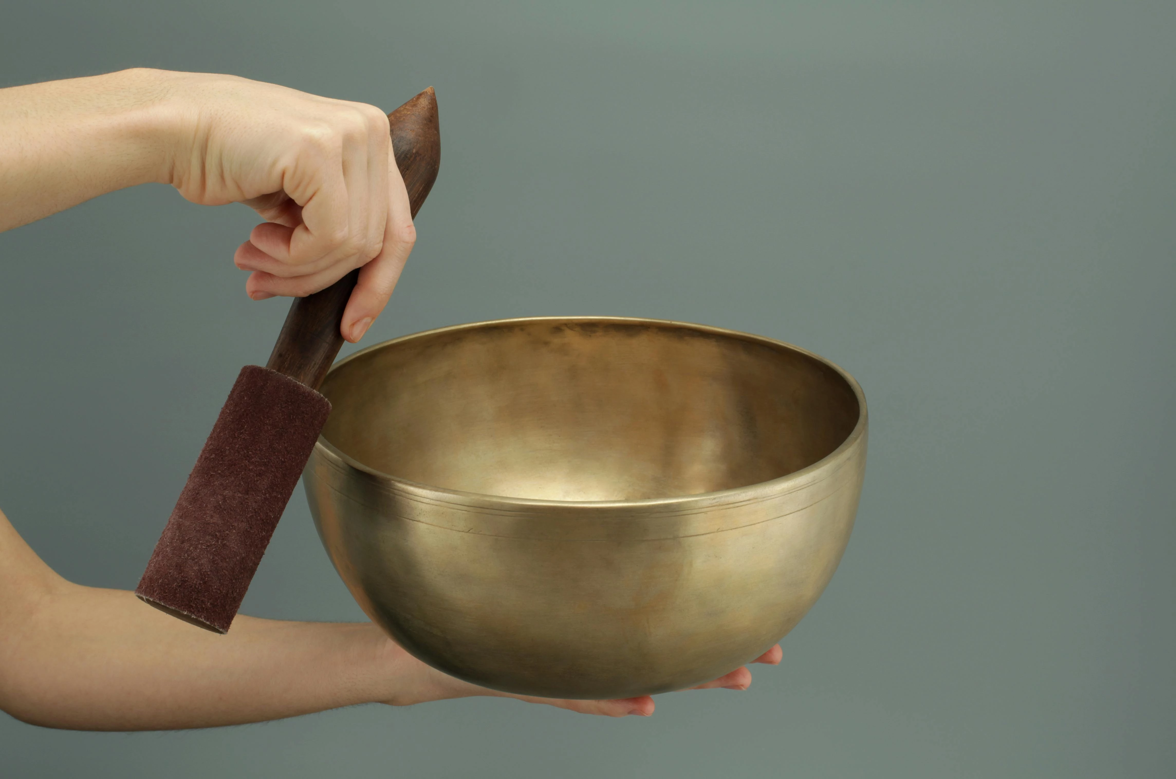 a person holding a singing bowl