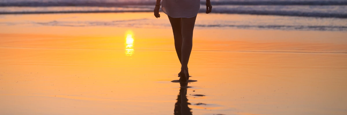 a woman walking on a beach