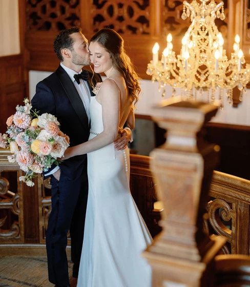 bride and groom posing in front of door