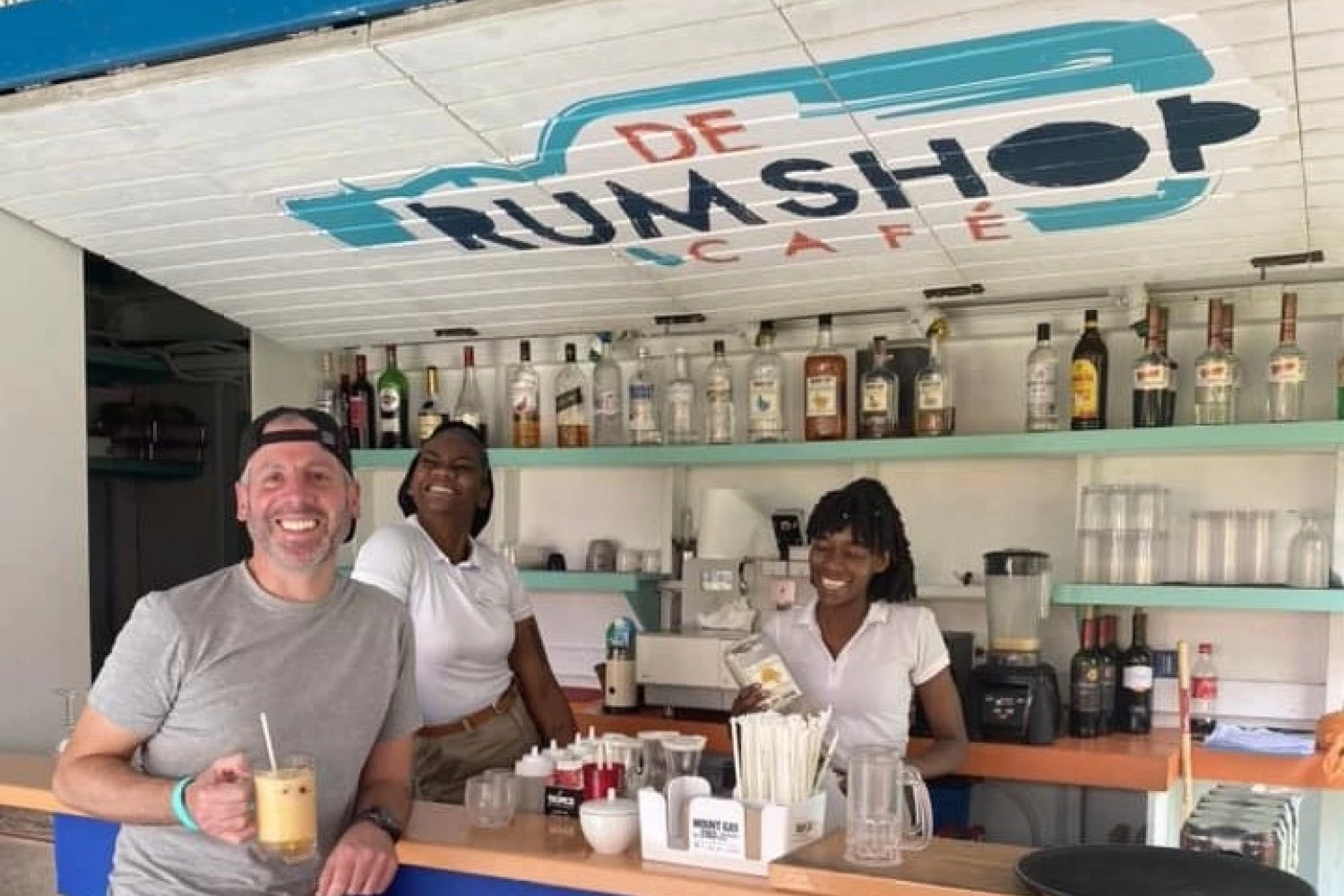 a group of people standing in a bar