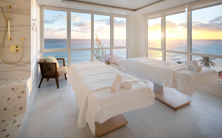 spa massage beds overlooking the ocean during sunset