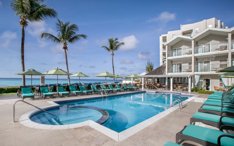 outdoor pool with teal lounge chairs