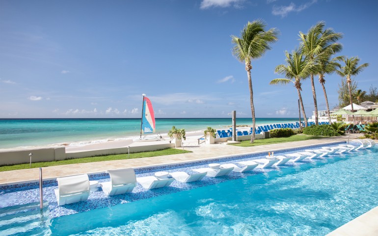 long pool with lounge chairs in the end overlooking the ocean