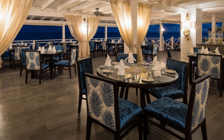 restaurant area with blue velvet chairs and tables