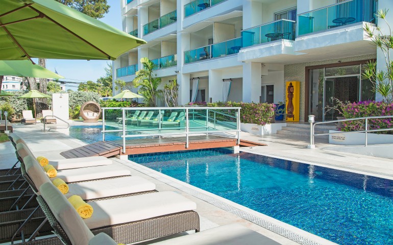 outdoor pool with bridge over the suites