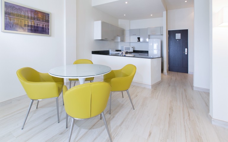 kitchen with dining table and yellow chairs