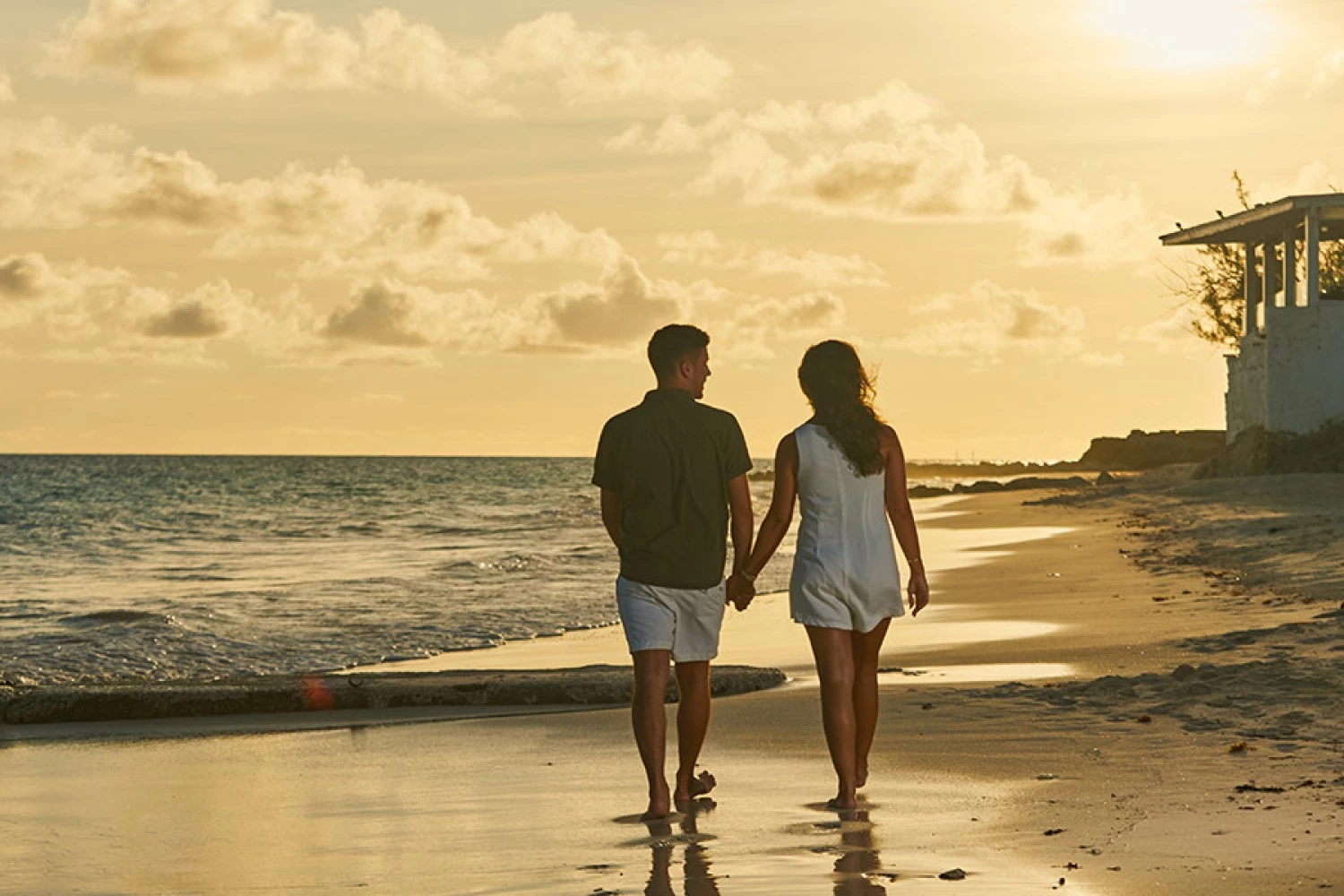 a man and woman walking on a beach