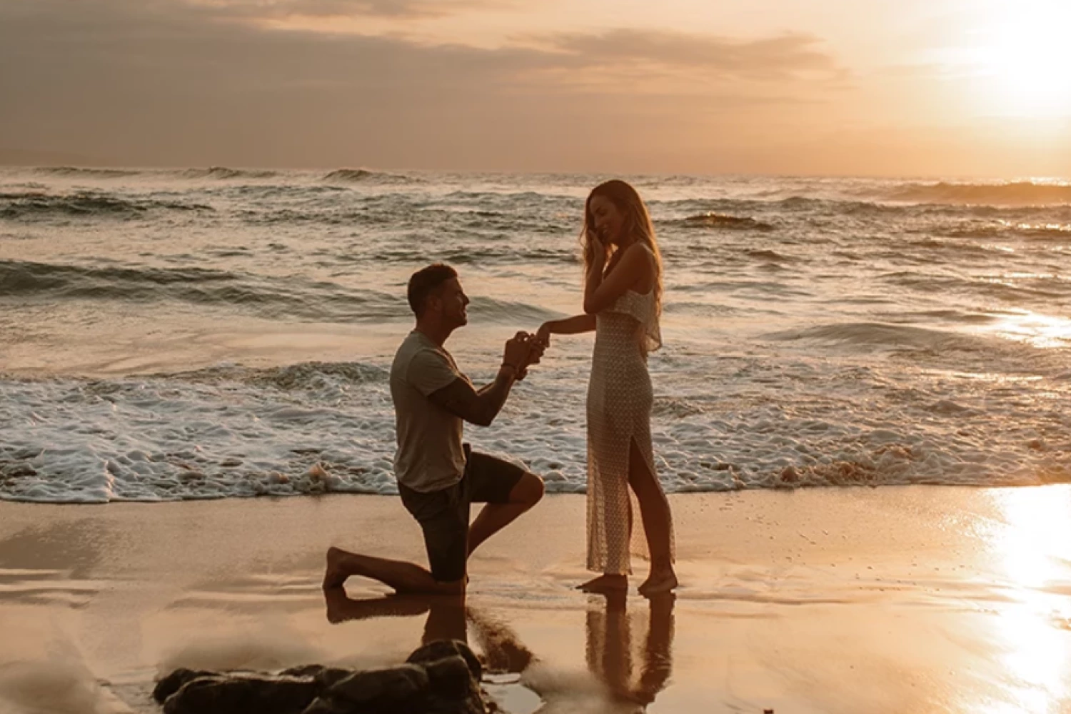 a man proposing to a woman on a beach