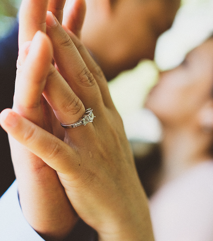 a woman's hand with a wedding ring on it