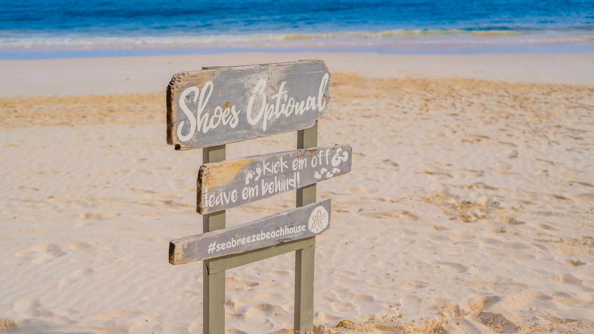 a sign on a beach