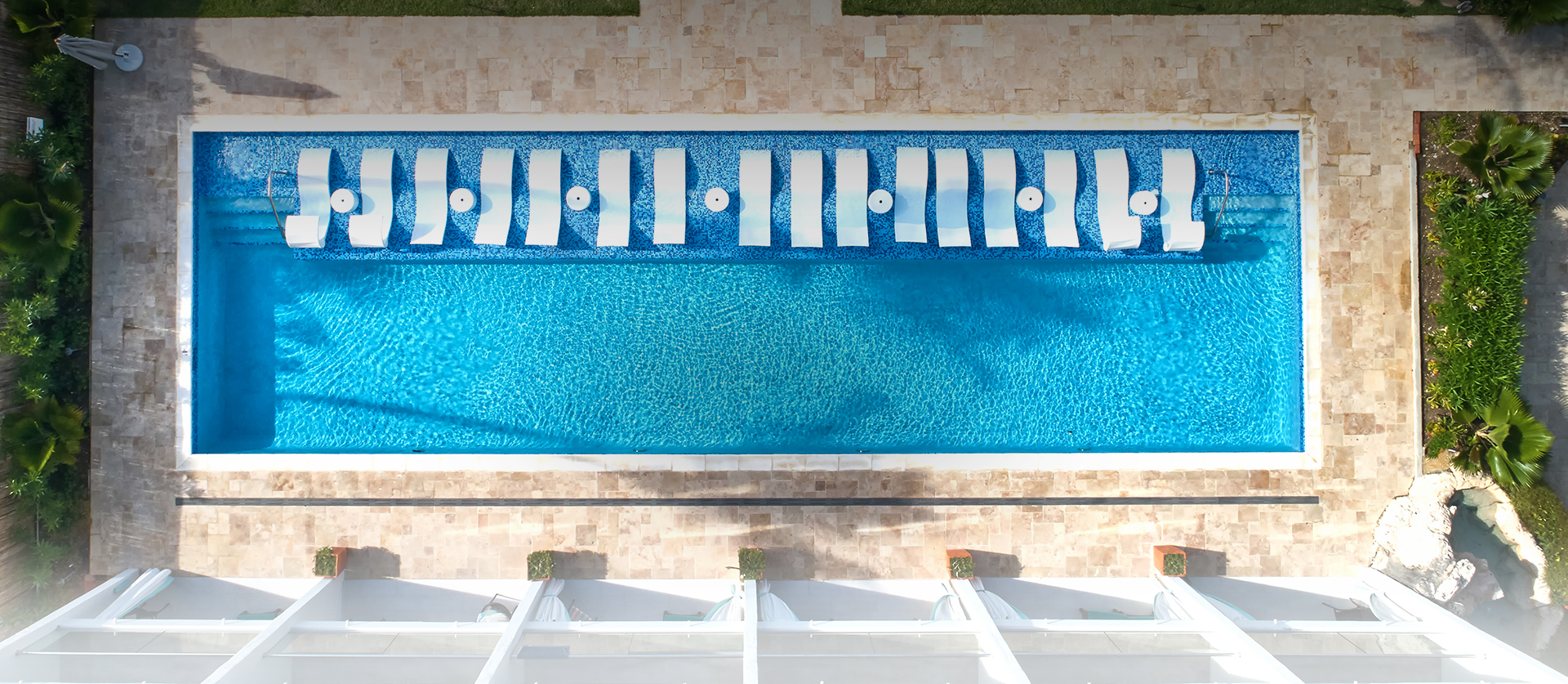 long pool with white lounge chairs