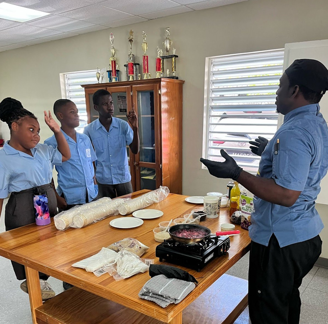 a group of people standing around a table
