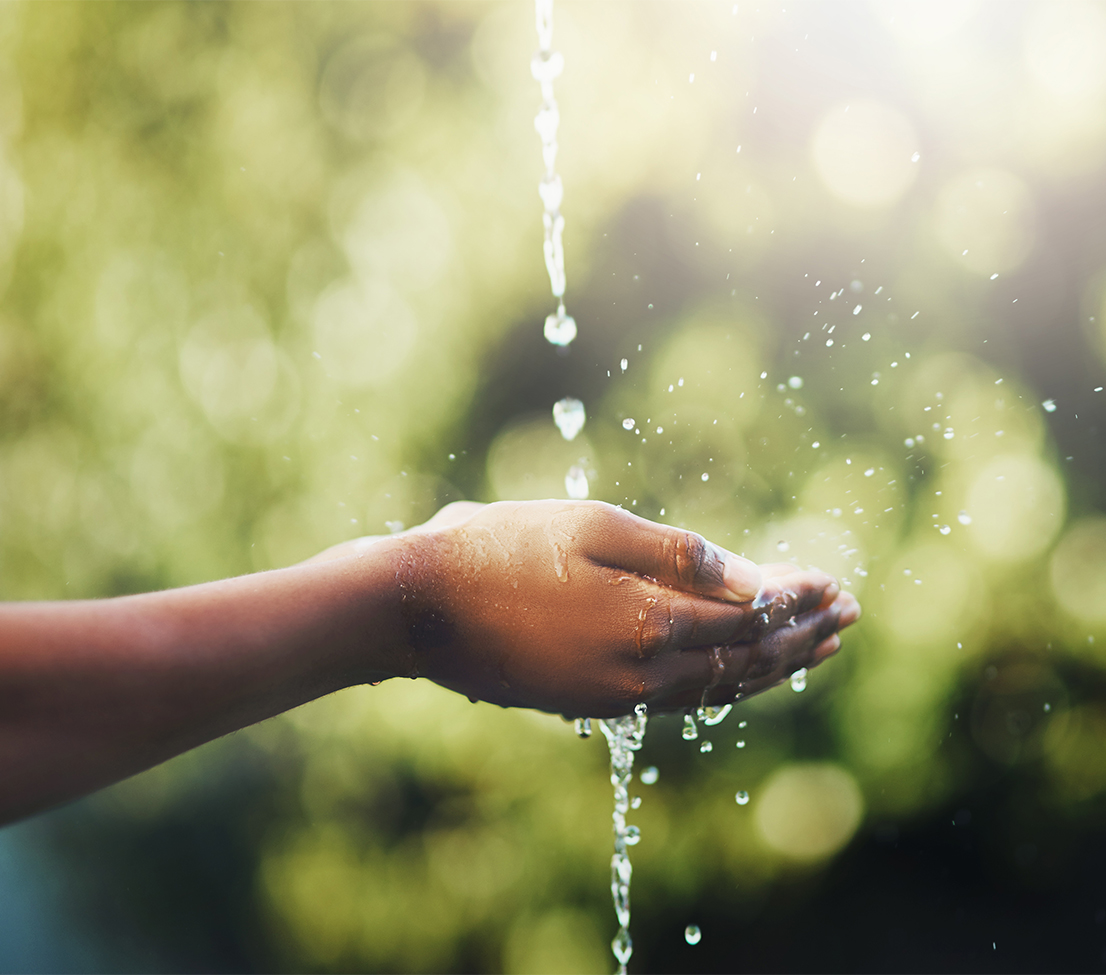 a person washing their hands under a stream of water