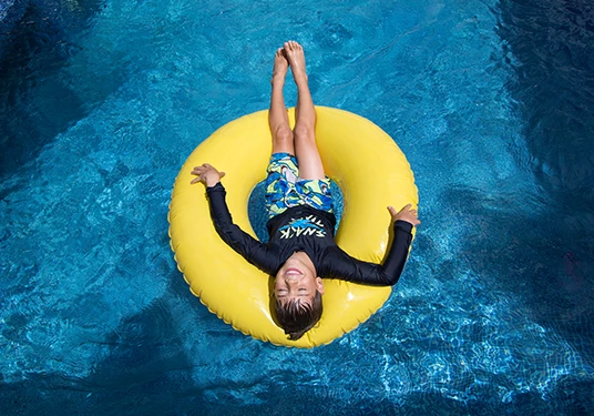 a person floating in a pool
