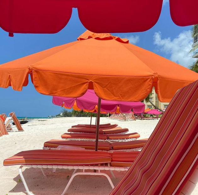 a beach with chairs and umbrellas