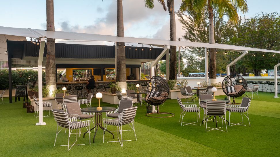 a patio area with chairs and tables