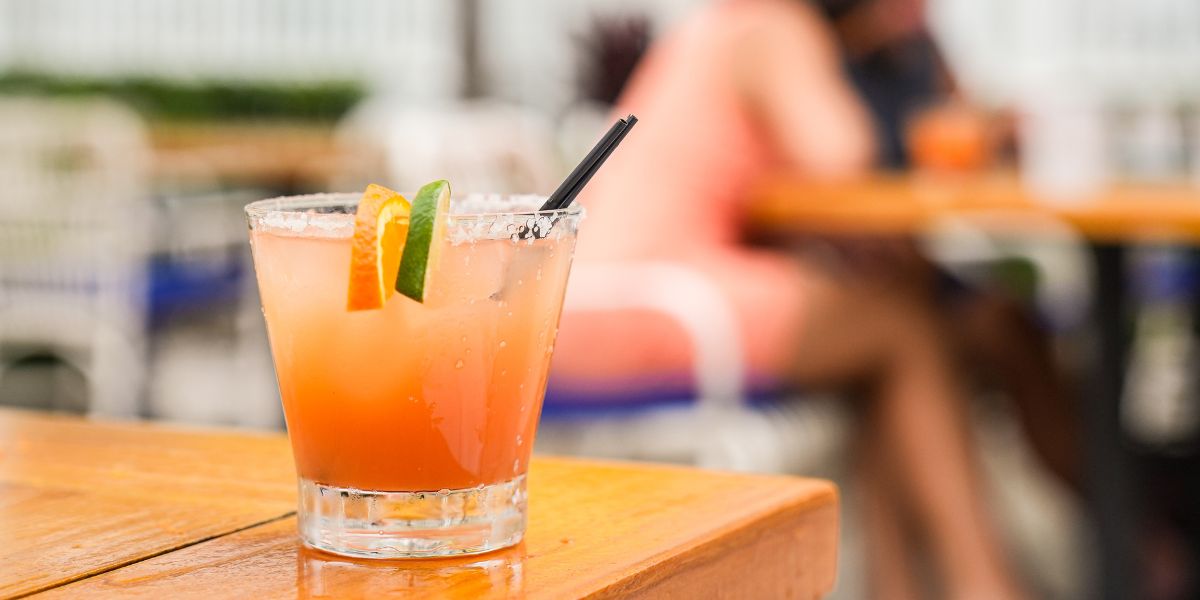 a drink with orange and lime slices on a table