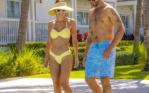 a man and woman in a swimsuit standing in a pool