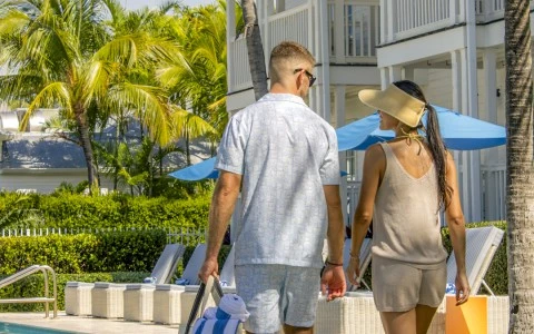 a man and woman walking by a pool