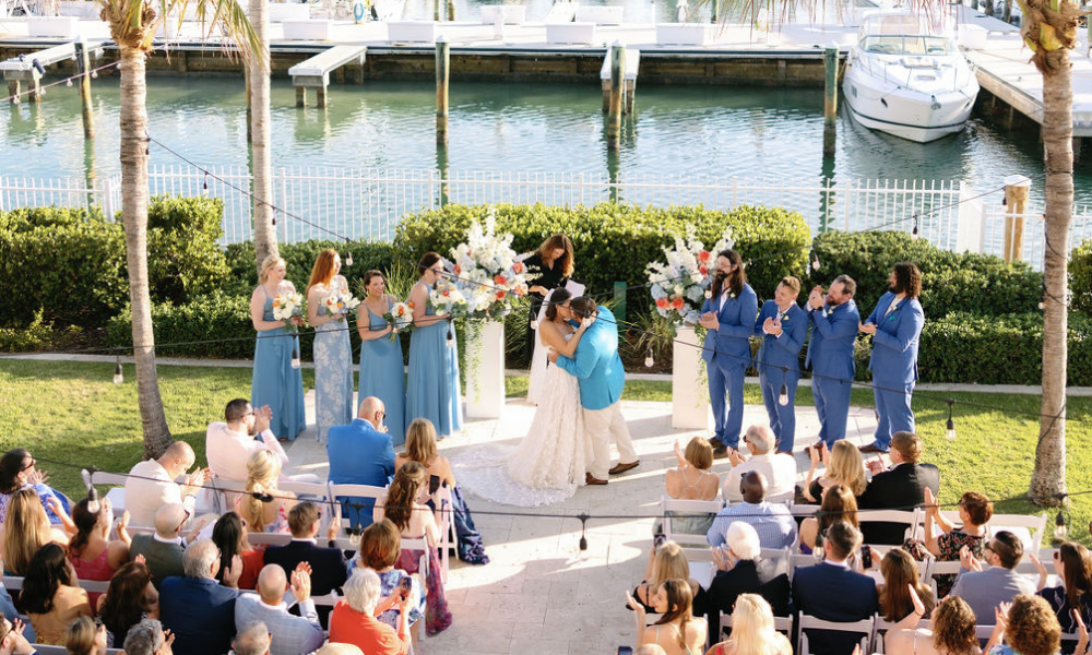 a man and woman kissing in front of a crowd of people