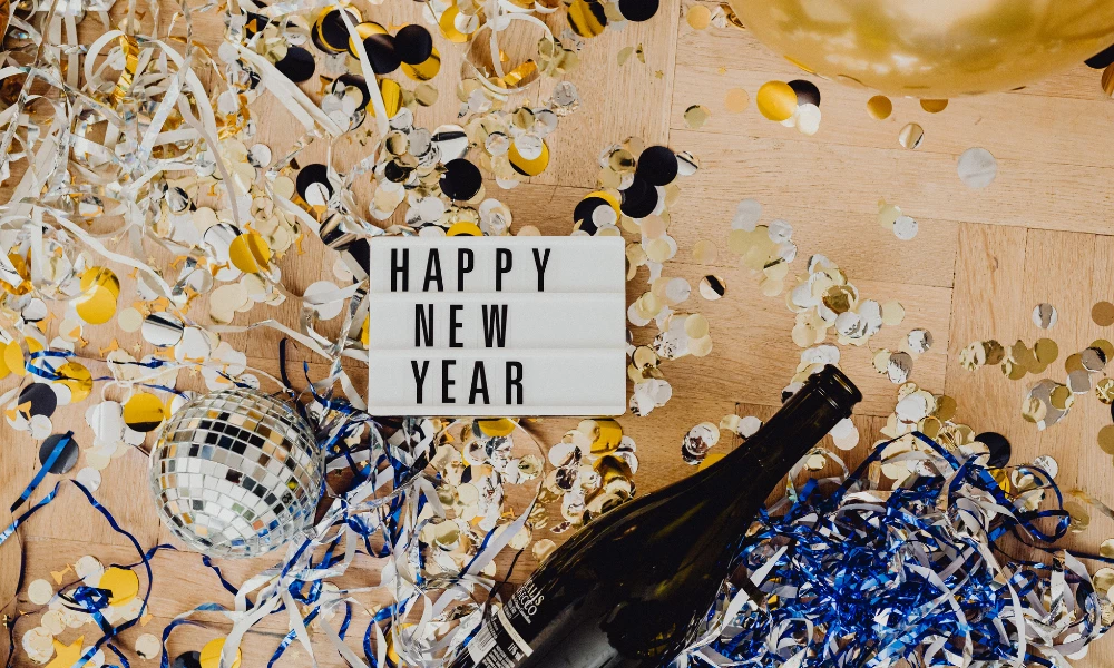 a bottle of champagne and confetti on a table